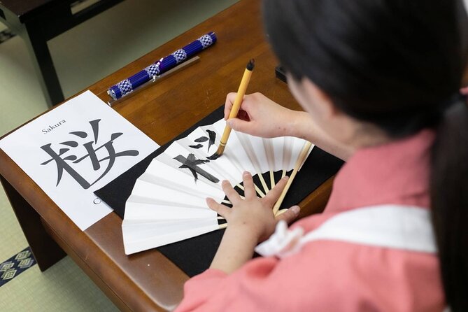 Learning Zen of Japanese Calligraphy in kimono near Osaka Castle - Choosing kanji: turning a word into a lesson in stroke order