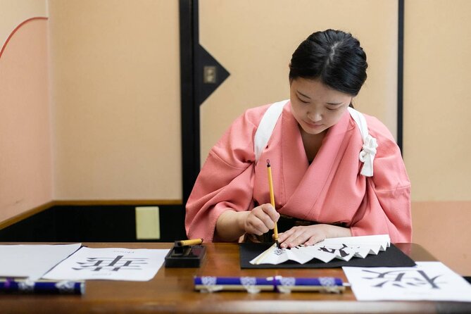 Learning Zen of Japanese Calligraphy in kimono near Osaka Castle - Your name in kanji: the surprise wooden tags souvenir